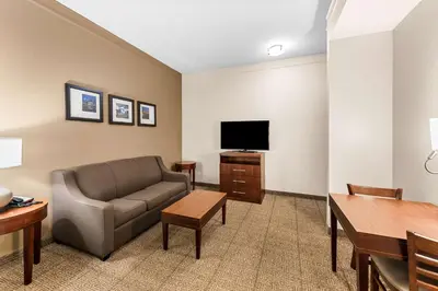 a living room with a couch and a flat screen tv at Comfort Inn & Suites Heath - Newark South in Heath