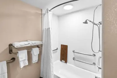 a bathroom with a shower and a bath tub at Comfort Inn & Suites Heath - Newark South in Heath