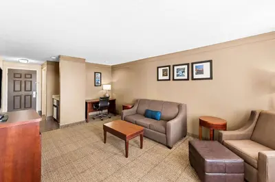 a living room with a couch and a desk at Comfort Inn & Suites Heath - Newark South in Heath