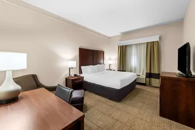 a hotel room with a bed and a desk at Comfort Inn & Suites Heath - Newark South in Heath
