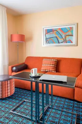 a living room with a couch and a table with a laptop at Fairfield Inn & Suites Mansfield Ontario in Mansfield