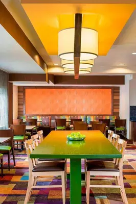 a dining room with a green table and chairs at Fairfield Inn & Suites Mansfield Ontario in Mansfield