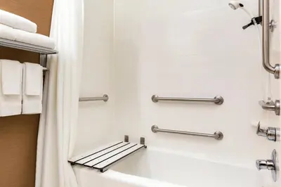 a bathroom with a bath tub and towels at Fairfield Inn & Suites by Marriott Toledo Maumee in Maumee