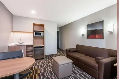 a living room with a couch and a table at Microtel Inn & Suites by Wyndham New Martinsville in New Martinsville