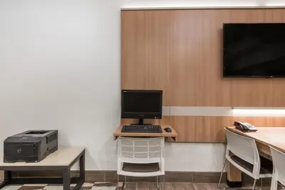 a room with a computer on a desk with a printer at Microtel Inn & Suites by Wyndham New Martinsville in New Martinsville