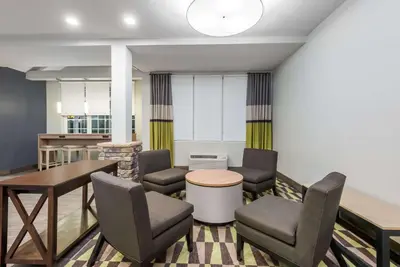 a living room with chairs and a table at Microtel Inn & Suites by Wyndham New Martinsville in New Martinsville