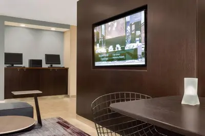 a waiting room with a tv on a wall at Courtyard by Marriott Dayton North in Dayton