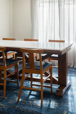 a wooden table with chairs around it in a room at Fairfield Inn and Suites by Marriott Fort Wayne in Fort Wayne