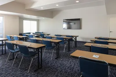 a classroom with tables and chairs and a tv at Fairfield Inn and Suites by Marriott Fort Wayne in Fort Wayne