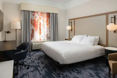 a hotel room with a large bed and a desk at Fairfield Inn and Suites by Marriott Fort Wayne in Fort Wayne