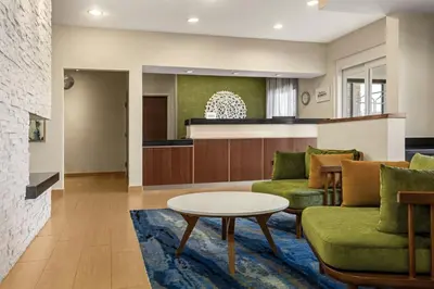 a living room with a couch and a table at Fairfield Inn & Suites Findlay in Findlay