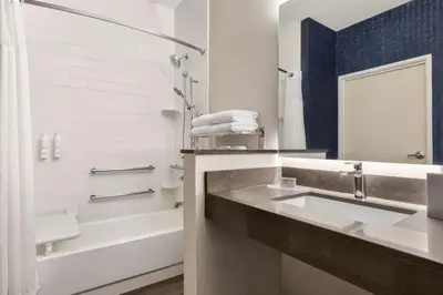 a bathroom with a sink and a bath tub at Fairfield Inn & Suites Findlay in Findlay