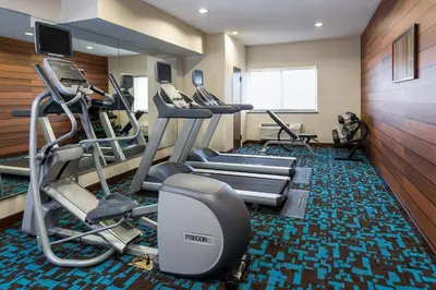 a gym with treadmills and ellipticals in a room at Fairfield Inn & Suites Findlay in Findlay