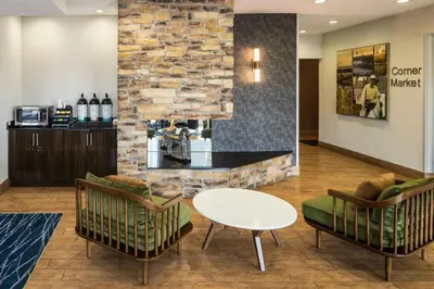a lobby with a counter and two chairs and a table at Fairfield Inn by Marriott Richmond in New Paris