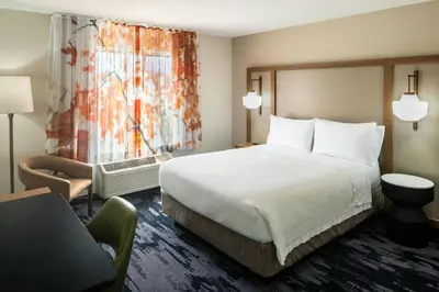 a hotel room with a bed and a window at Fairfield Inn by Marriott Richmond in New Paris