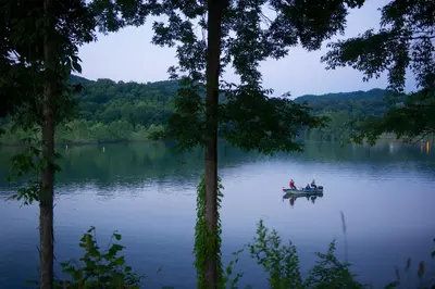 two people in a boat on a lake at Stonewall Resort in Roanoke