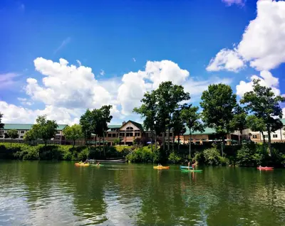 a group of boats on a river with houses at Stonewall Resort in Roanoke
