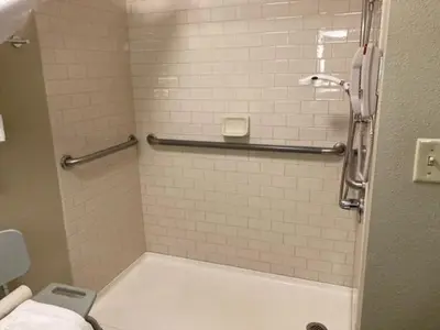 a bathroom with a shower and a toilet in it at Stonewall Resort in Roanoke