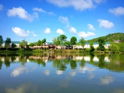 a view of a lake with trees and buildings at Stonewall Resort in Roanoke