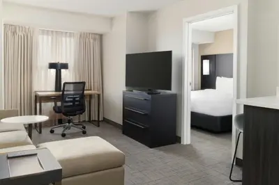 a hotel room with a television and a bed at Residence Inn Dayton North in Dayton