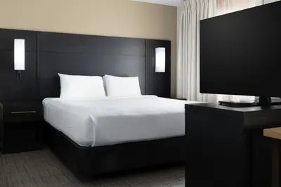 a bedroom with a bed and a flat screen tv at Residence Inn Dayton North in Dayton