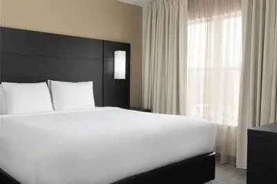 a bedroom with a large white bed and a window at Residence Inn Dayton North in Dayton