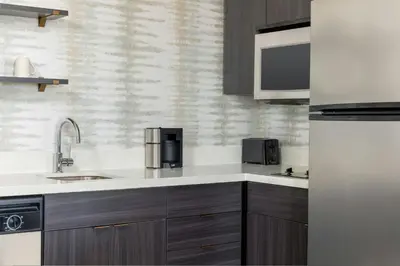 a kitchen with a sink and a refrigerator at Residence Inn Dayton North in Dayton