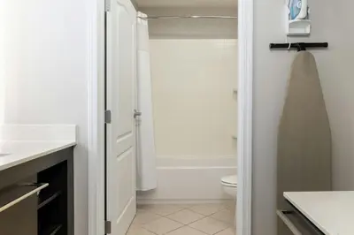 a white bathroom with a toilet and a shower at Residence Inn Dayton North in Dayton