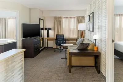 a hotel room with a bed and a living room at Residence Inn Dayton North in Dayton