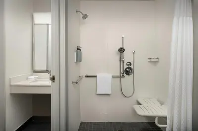a bathroom with a shower and a toilet and a sink at Courtyard by Marriott Dayton Beavercreek in Beavercreek