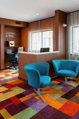 an office with two chairs and a reception desk at Fairfield Inn Muncie in Muncie
