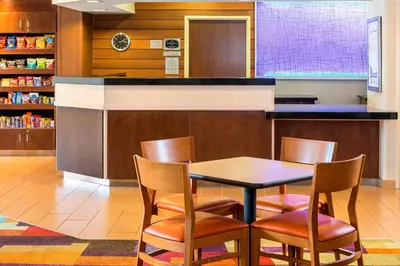 a dining room with a table and chairs at Fairfield Inn Muncie in Muncie