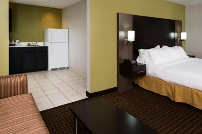 a hotel room with a bed and a kitchen at Holiday Inn Express & Suites Bucyrus by IHG in Bucyrus