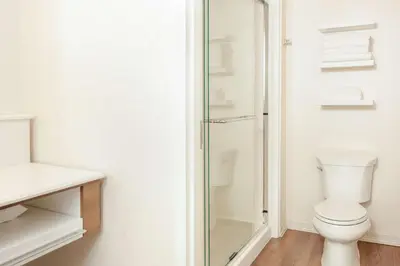 a bathroom with a toilet and a glass shower at Hampton Inn & Suites Niles/Warren, OH in Niles