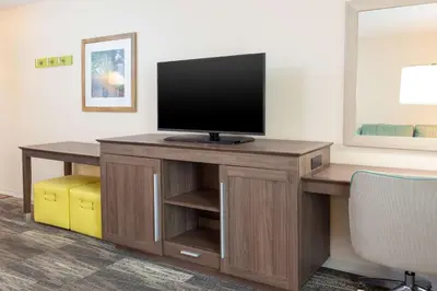 a room with a desk with a television on it at Hampton Inn & Suites Niles/Warren, OH in Niles