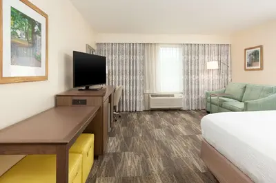 a hotel room with a bed and a flat screen tv at Hampton Inn & Suites Niles/Warren, OH in Niles