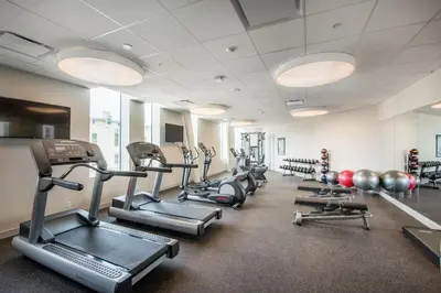 a gym with rows of treadmills and weights at The Hotel at Oberlin in Oberlin