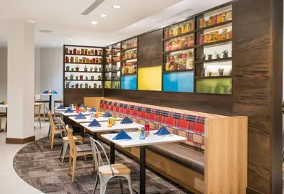 a row of tables in a restaurant with books at The Hotel at Oberlin in Oberlin