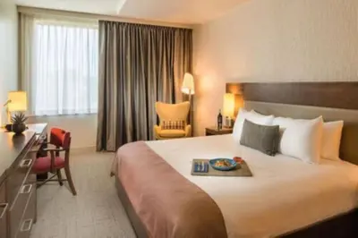 a hotel room with a large bed with a tray on it at The Hotel at Oberlin in Oberlin