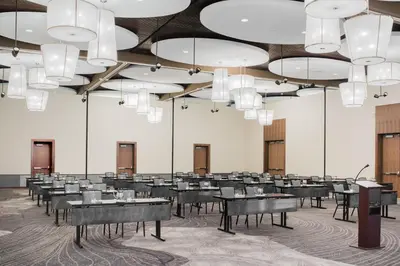 a large room with tables and chairs and chandeliers at The Hotel at Oberlin in Oberlin