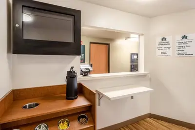 a bathroom with a sink and a mirror at HomeTowne Studios by Red Roof Columbus in Columbus