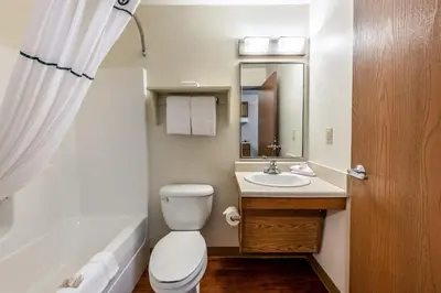 a bathroom with a toilet and a sink at HomeTowne Studios by Red Roof Columbus in Columbus