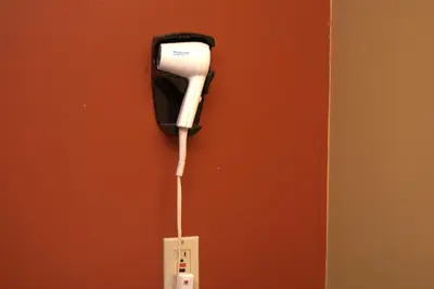 a hair dryer hanging on a wall at Commodore Resort in Put-in-Bay