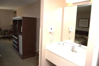 a bathroom with a sink and a mirror at Commodore Resort in Put-in-Bay