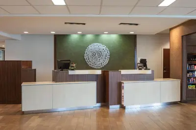 a lobby with reception desks and a green wall at Fairfield Inn & Suites by Marriott Chillicothe in Chillicothe