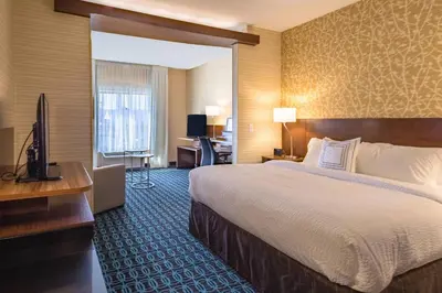 a hotel room with a large bed and a desk at Fairfield Inn & Suites by Marriott Chillicothe in Chillicothe