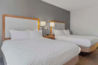 a hotel room with two beds and two lamps at Hampton Inn & Suites Columbus Scioto Downs in Columbus