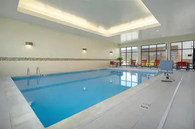 a large swimming pool with blue water in a building at Hampton Inn & Suites Columbus Scioto Downs in Columbus