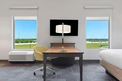a bedroom with a desk and a bed and a chair at Hampton Inn & Suites Columbus Scioto Downs in Columbus
