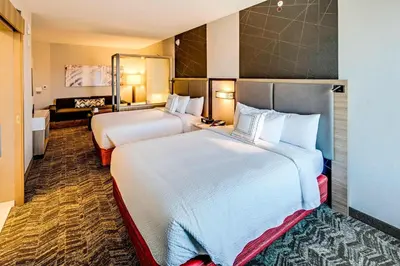 a hotel room with two beds and a couch at SpringHill Suites by Marriott Dayton Vandalia in Murlin Heights